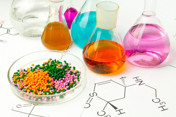 aqq Plastic raw material in granules against the background of Chemical Laboratory and reagents. Polypropylene, Ethylene, Polypropylene research in laboratory conditions